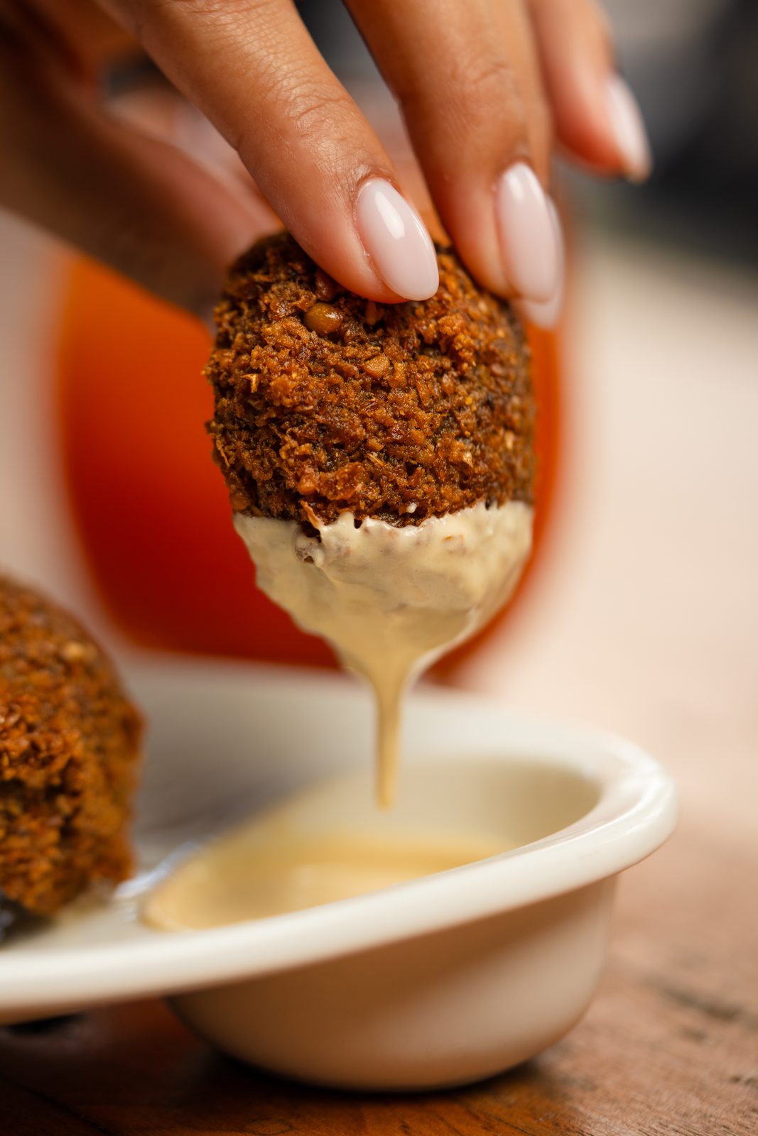 Falafel dipped in tahini