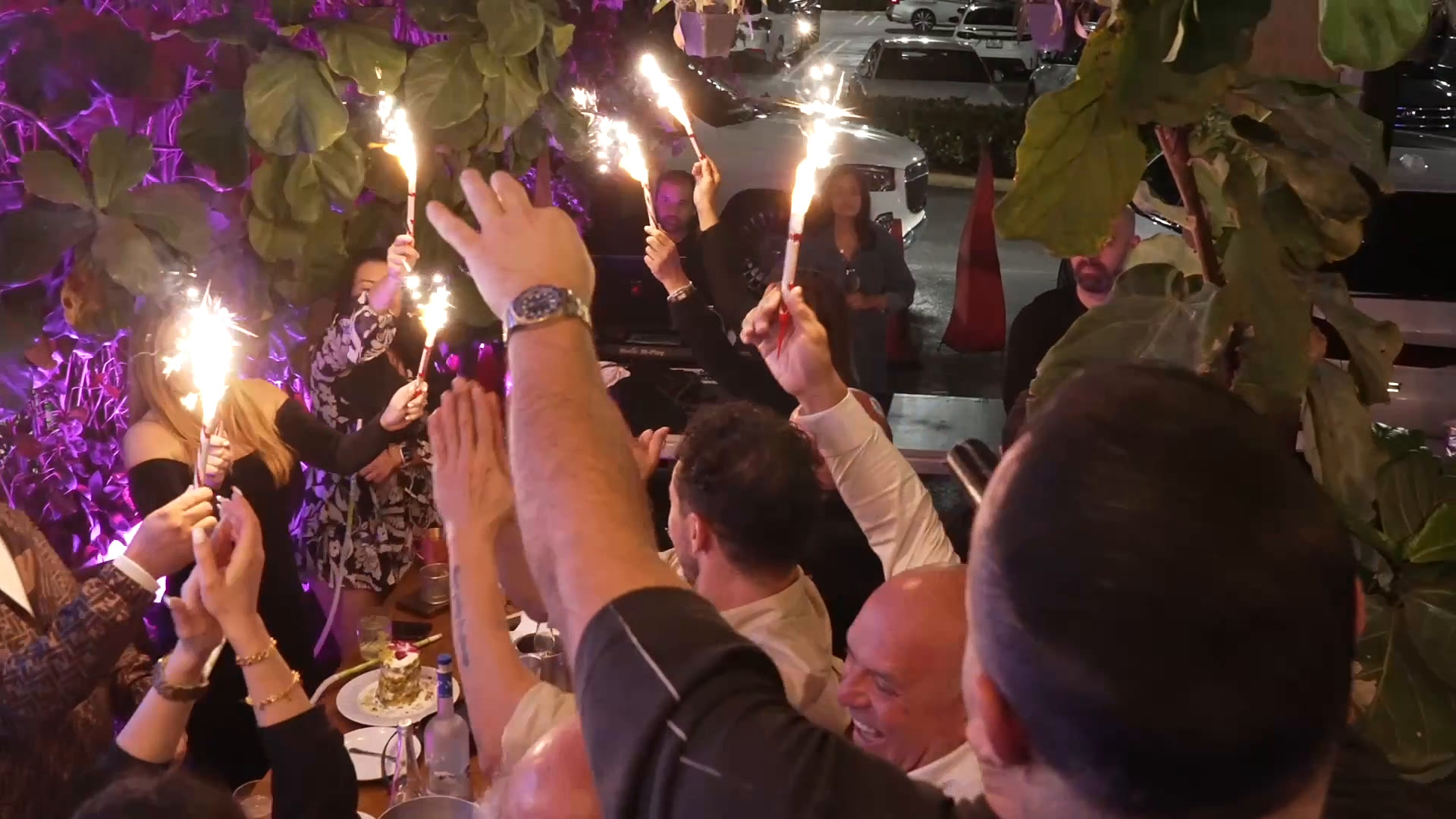 Guests raising sparklers during a celebration at Layali Miami