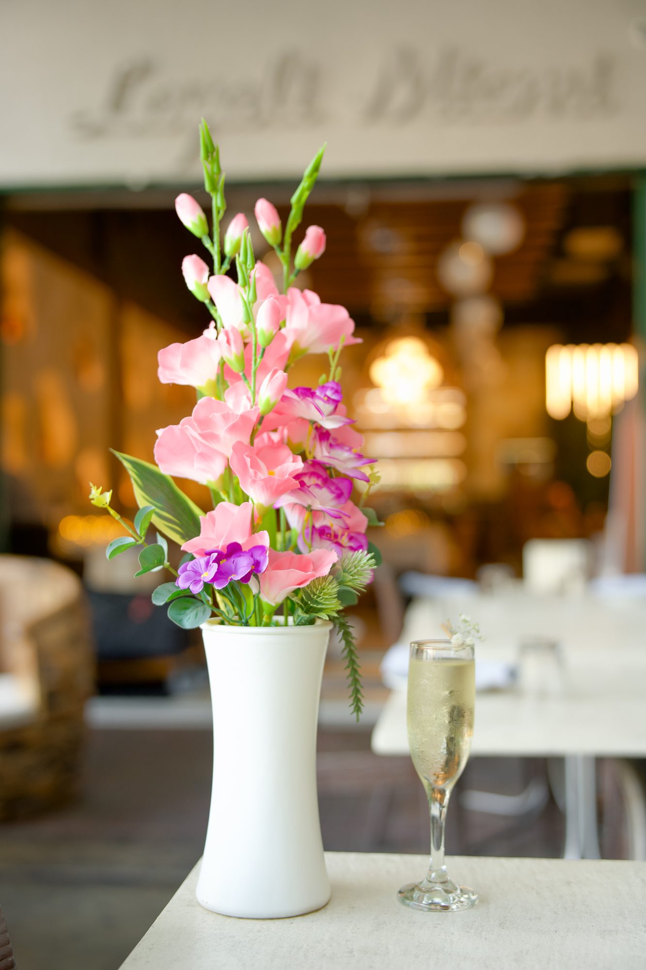 Fresh flowers and champagne on a table at Layali Miami