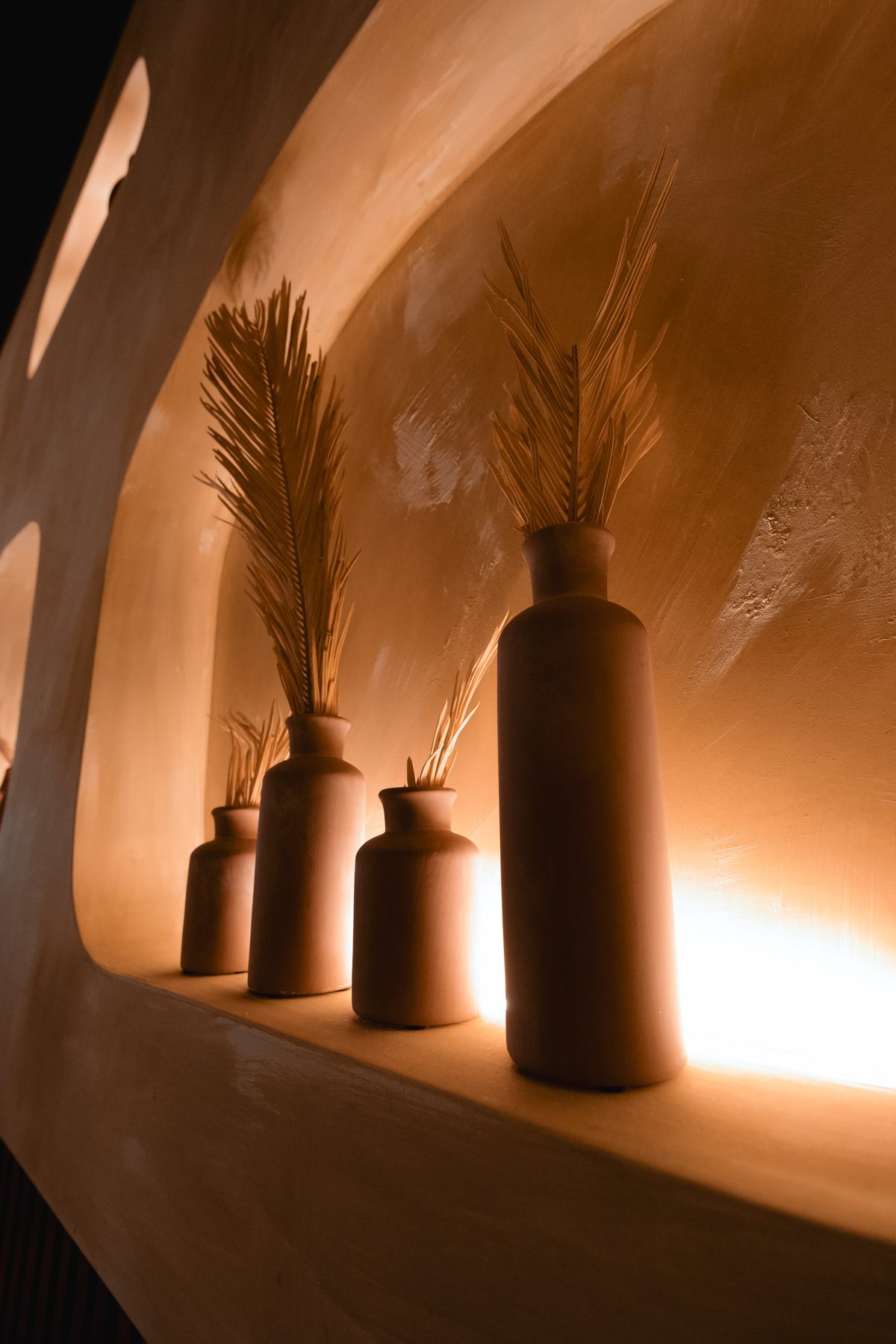 Terracotta vases in a glowing Layali Miami niche