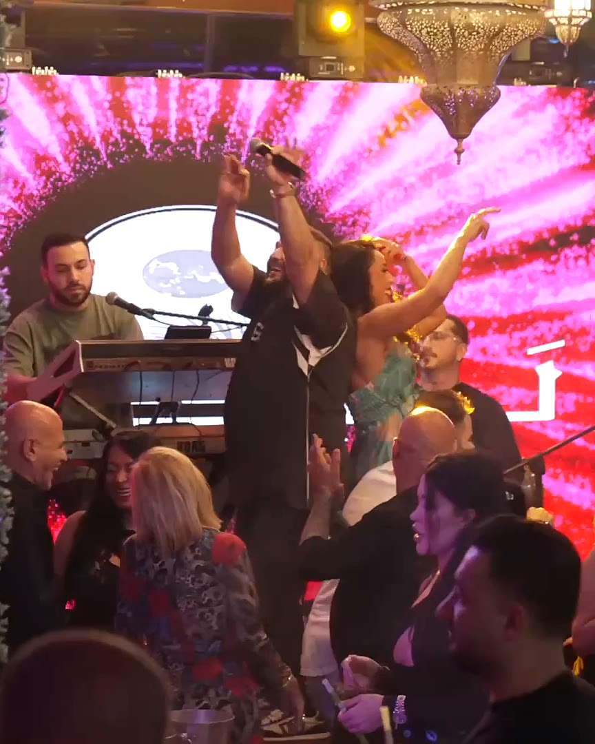 Performers under pink stage lights at Layali Miami