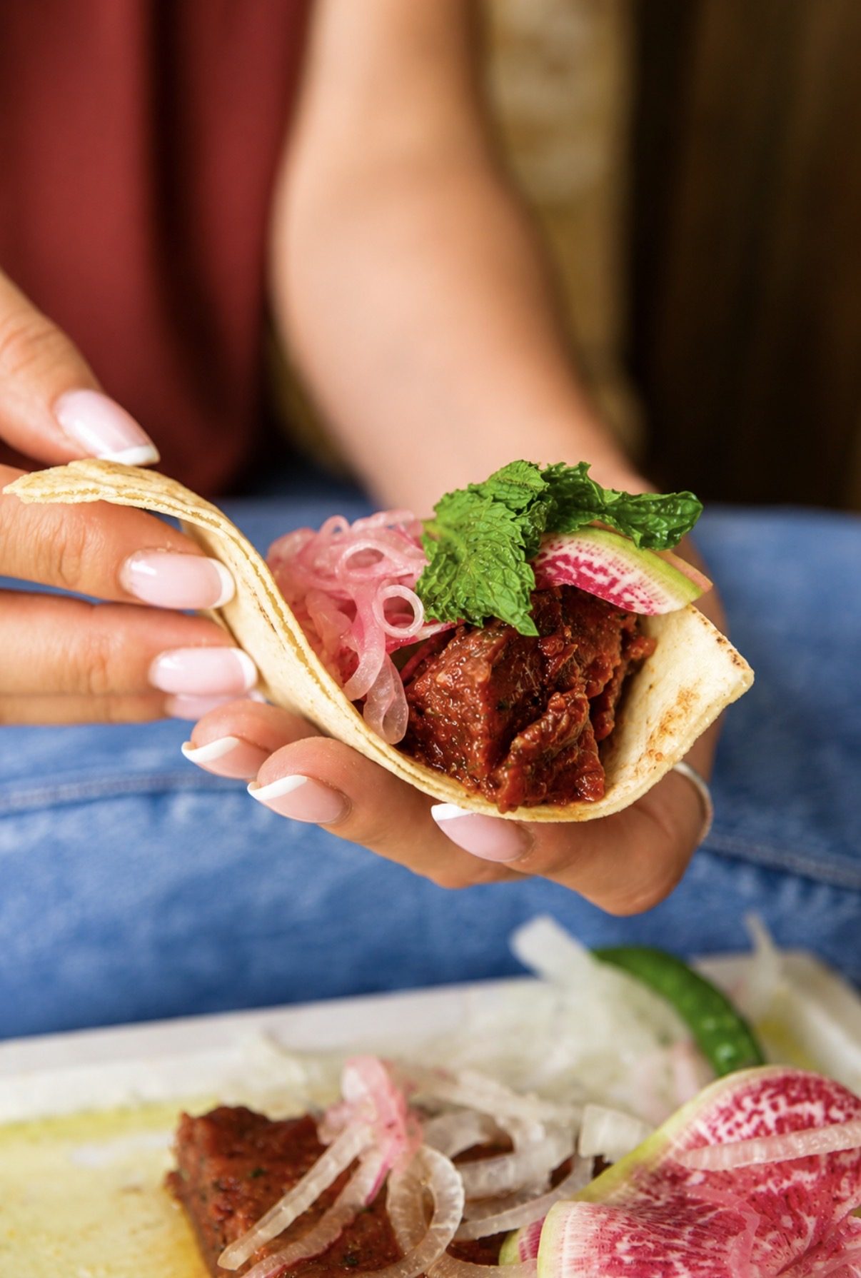 Pita bite with fresh mint and pickled onion at Layali Miami
